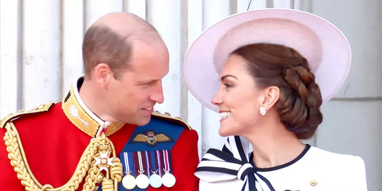 Prince William and Kate Middleton standing elegantly in matching formal attire.