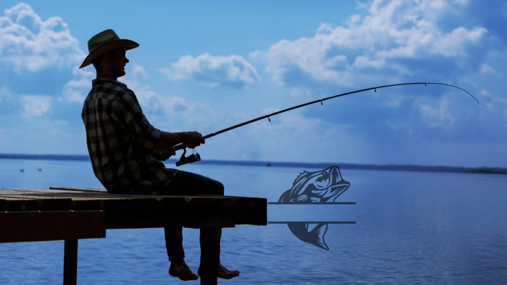 Man fishing by the lake during sunset